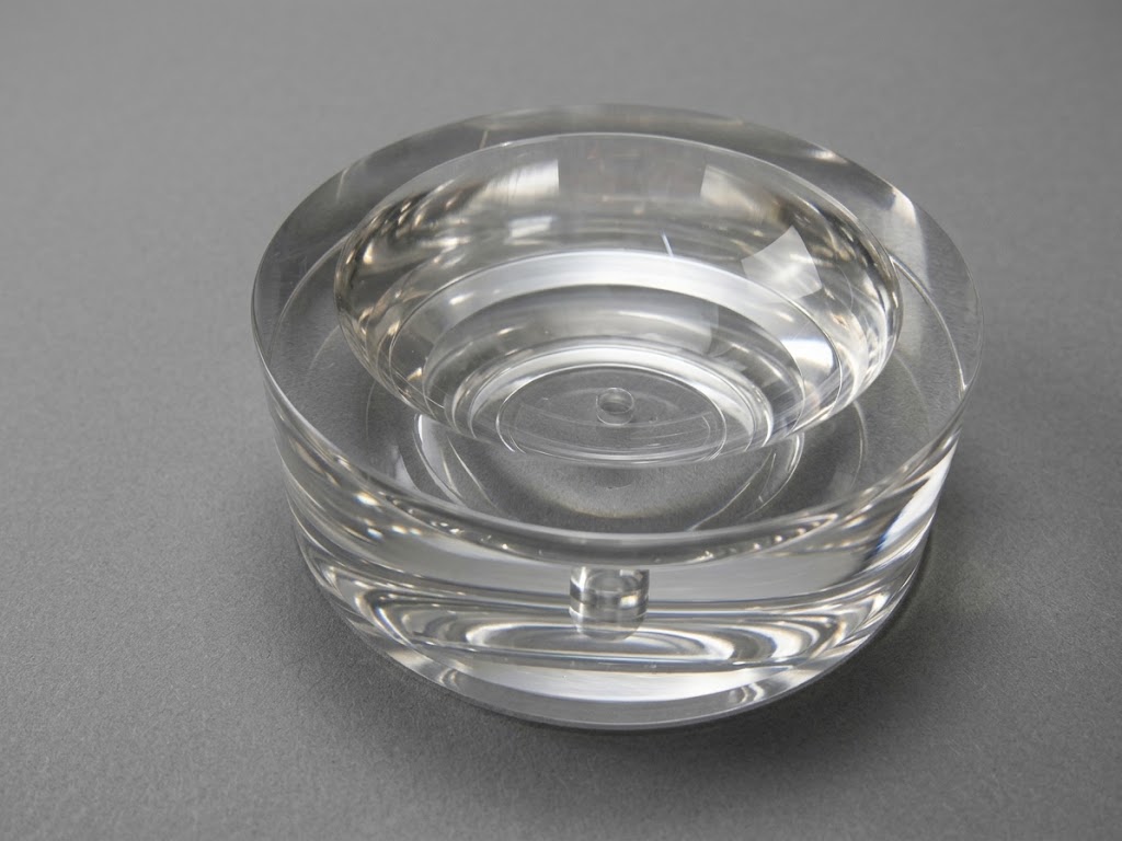 Polished optical glass part with a concave bowl and a small hole