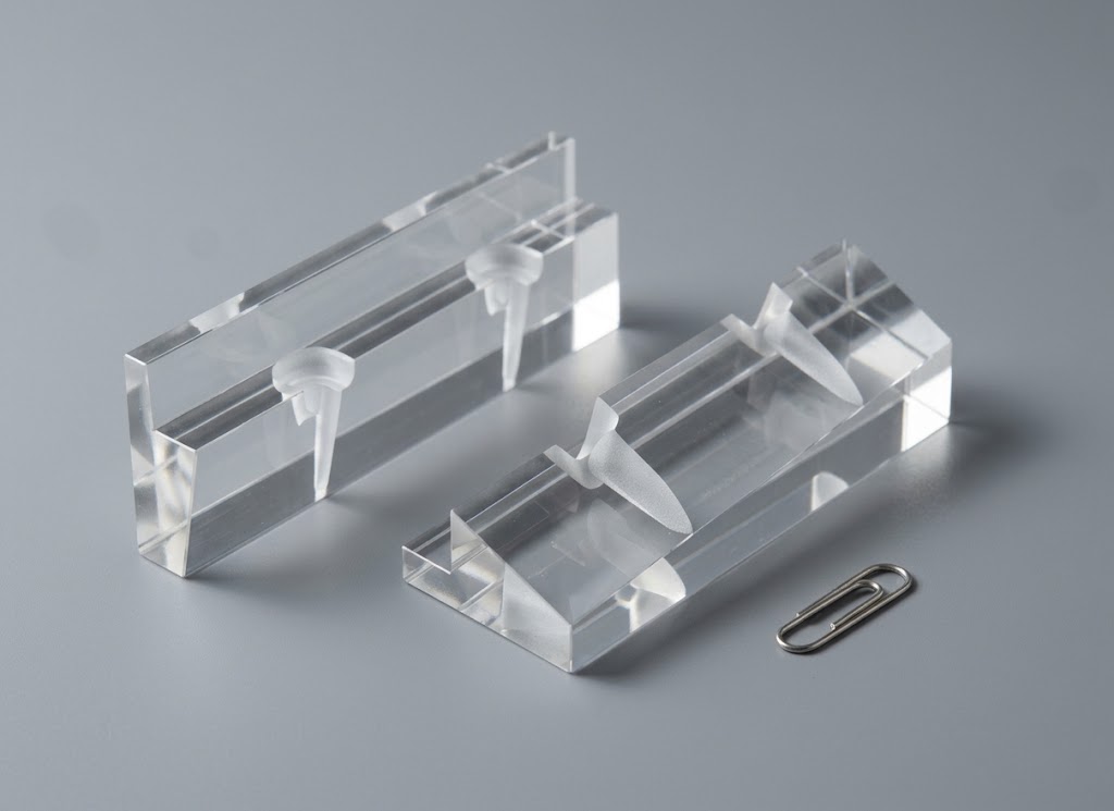 Two prisms with thin locating fins