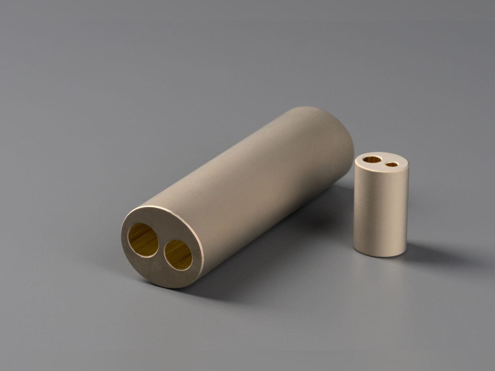 Two diffuse reflector cylinders with two holes of different sizes
