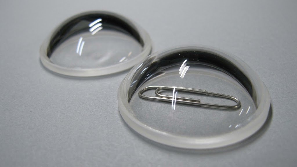 Two hemispherical glass domes with a paper clip